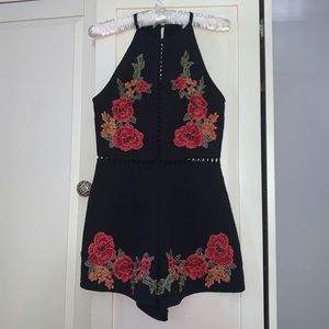 Black romper with floral embroidery